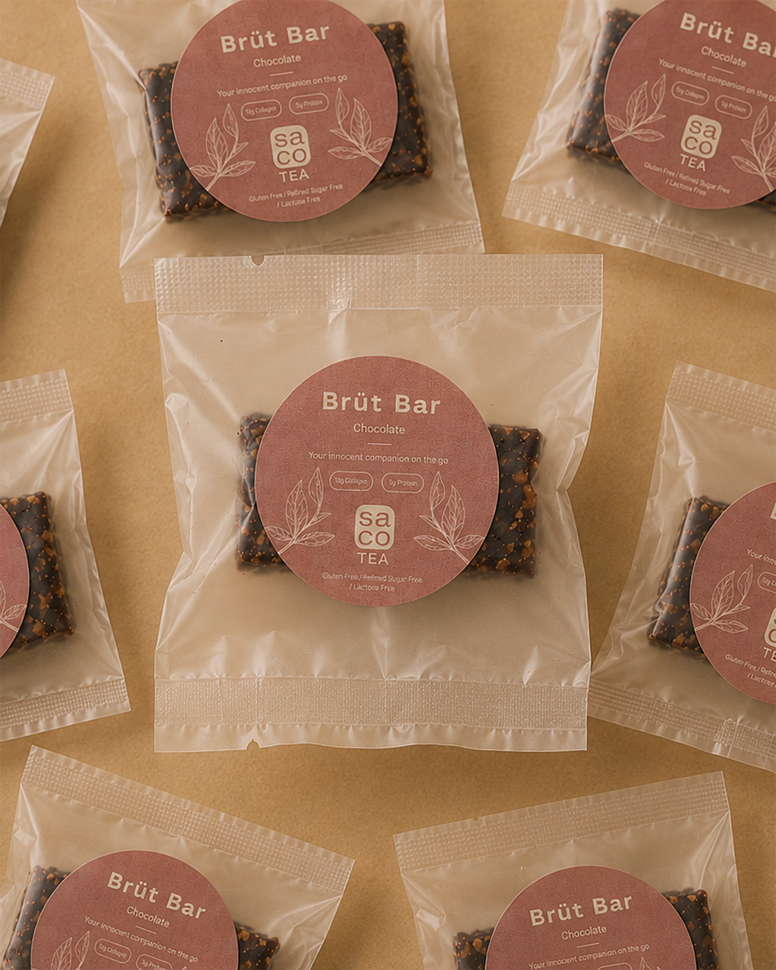Brüt Bar chocolate mini packages arranged on a beige background