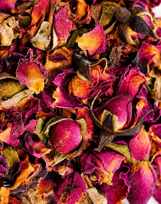 Jar of Rosie Tea with pink label beside rose petals, a cup of tea, and soft floral styling.