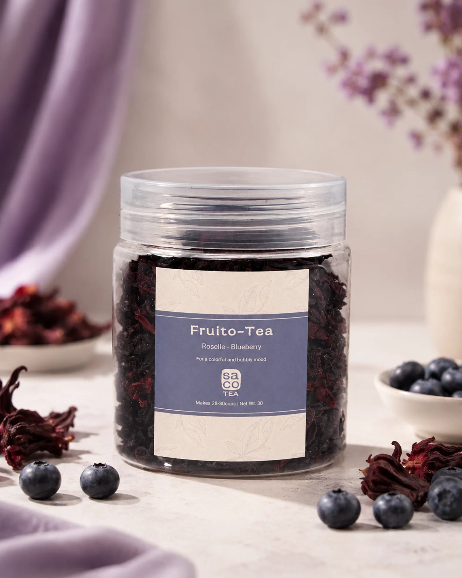Jar of Fruito-Tea with blueberries and hibiscus on a table