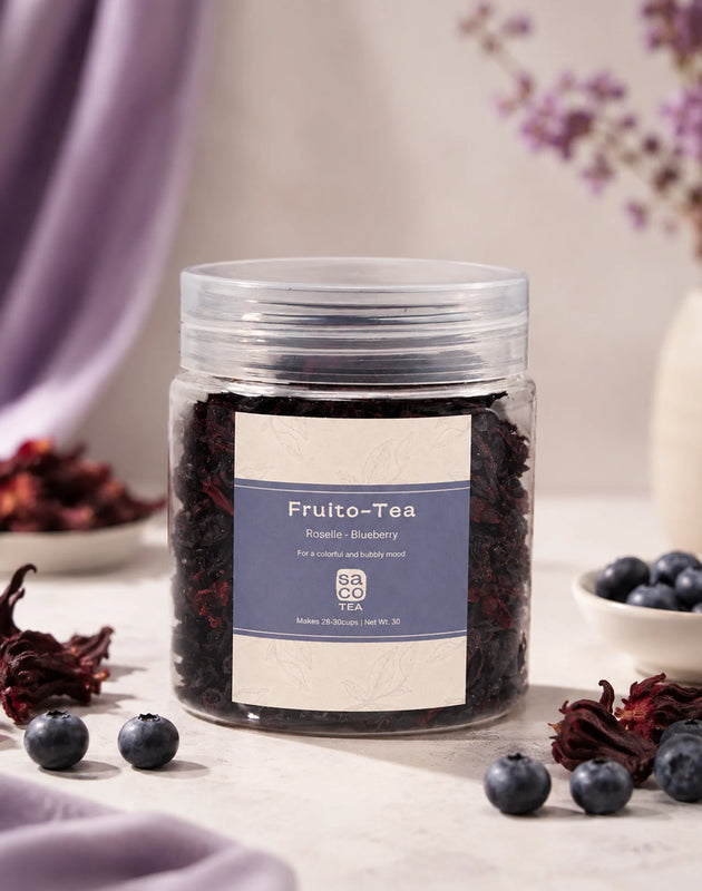 Jar of Fruito-Tea with blueberries and hibiscus on a table