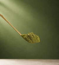 Matcha Powder with a green background reflecting the matcha